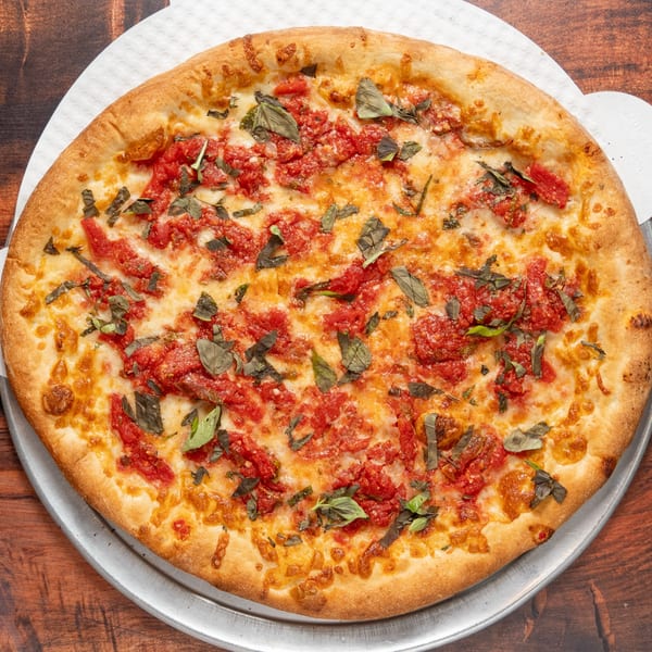 A whole Bruno Scipioni's Italian Ristorante & Pizzeria pizza with tomato sauce, cheese, and basil.